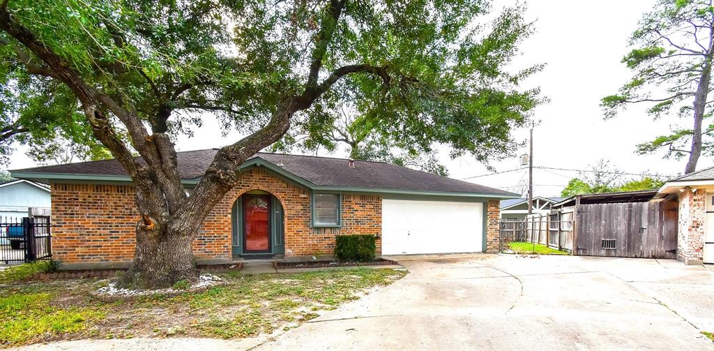 a view of large house with a yard and large tree