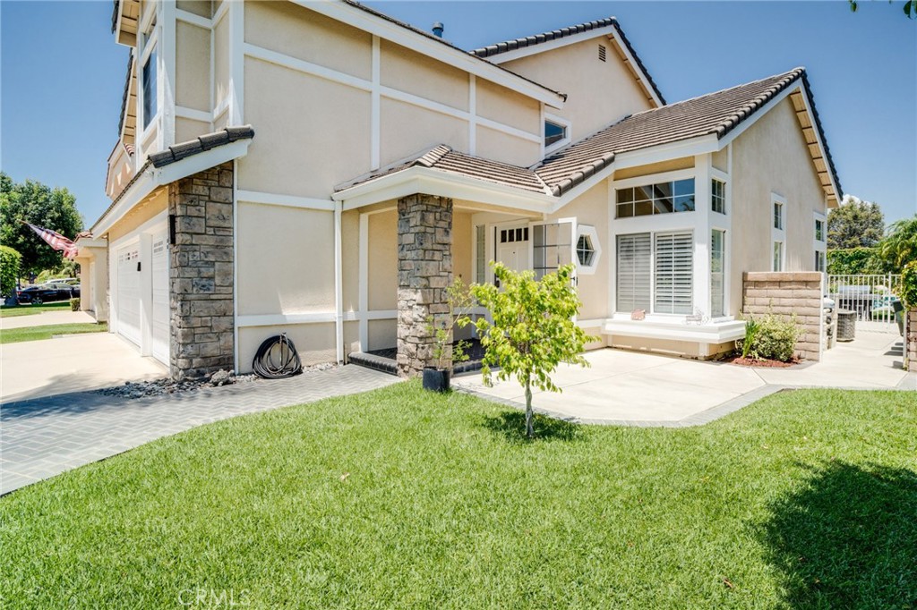 a front view of a house with a yard and porch