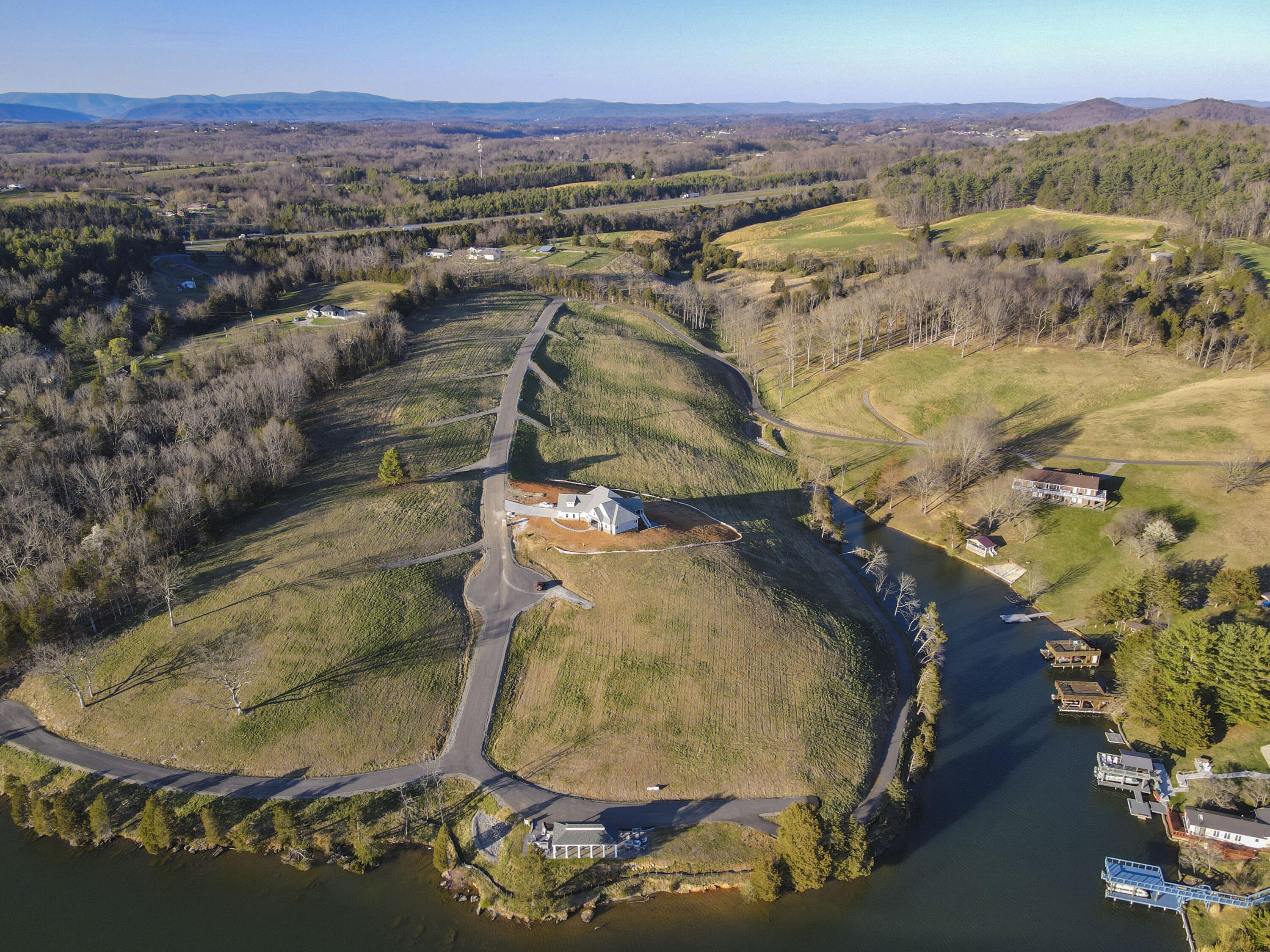 an aerial view of a house with a yard and lake view