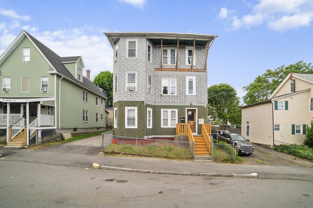 a front view of a house with a yard and table and chairs