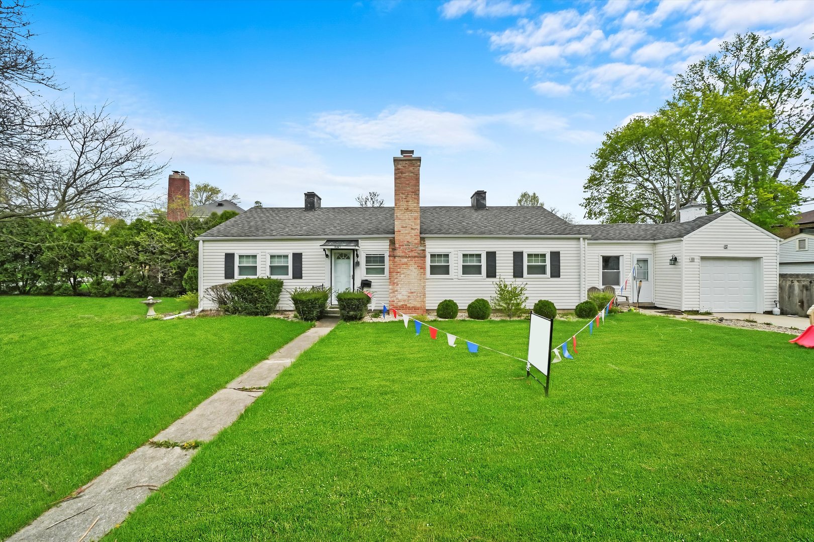 a front view of house with a garden and deck