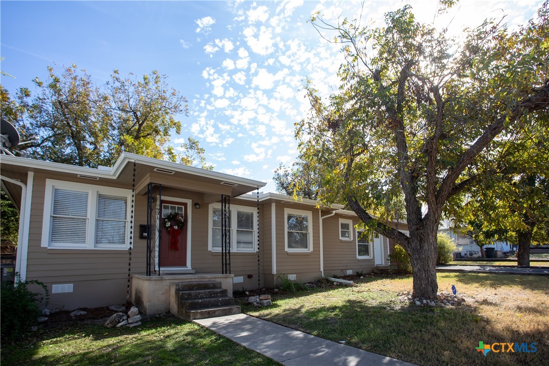 a front view of a house with a yard