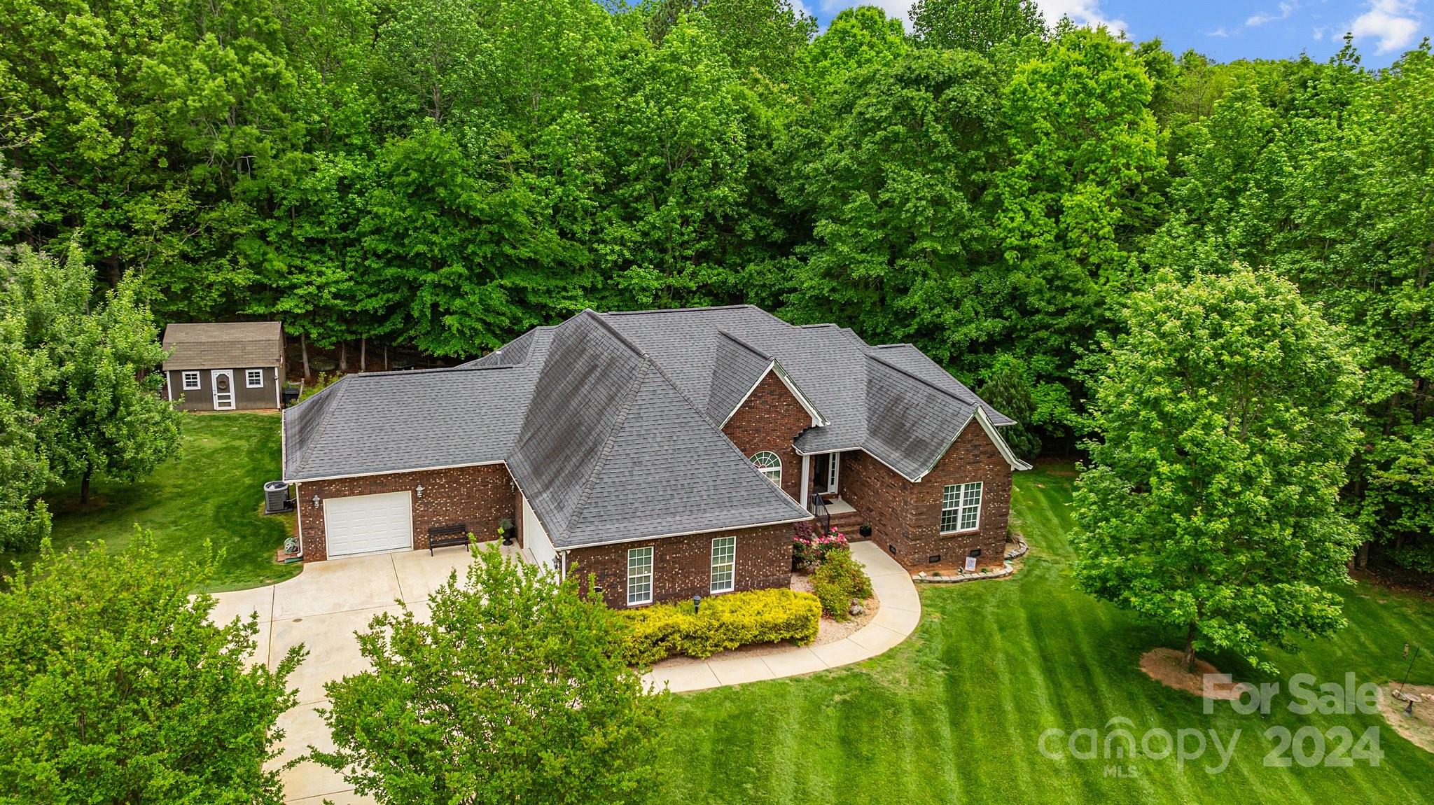 an aerial view of a house with swimming pool and garden