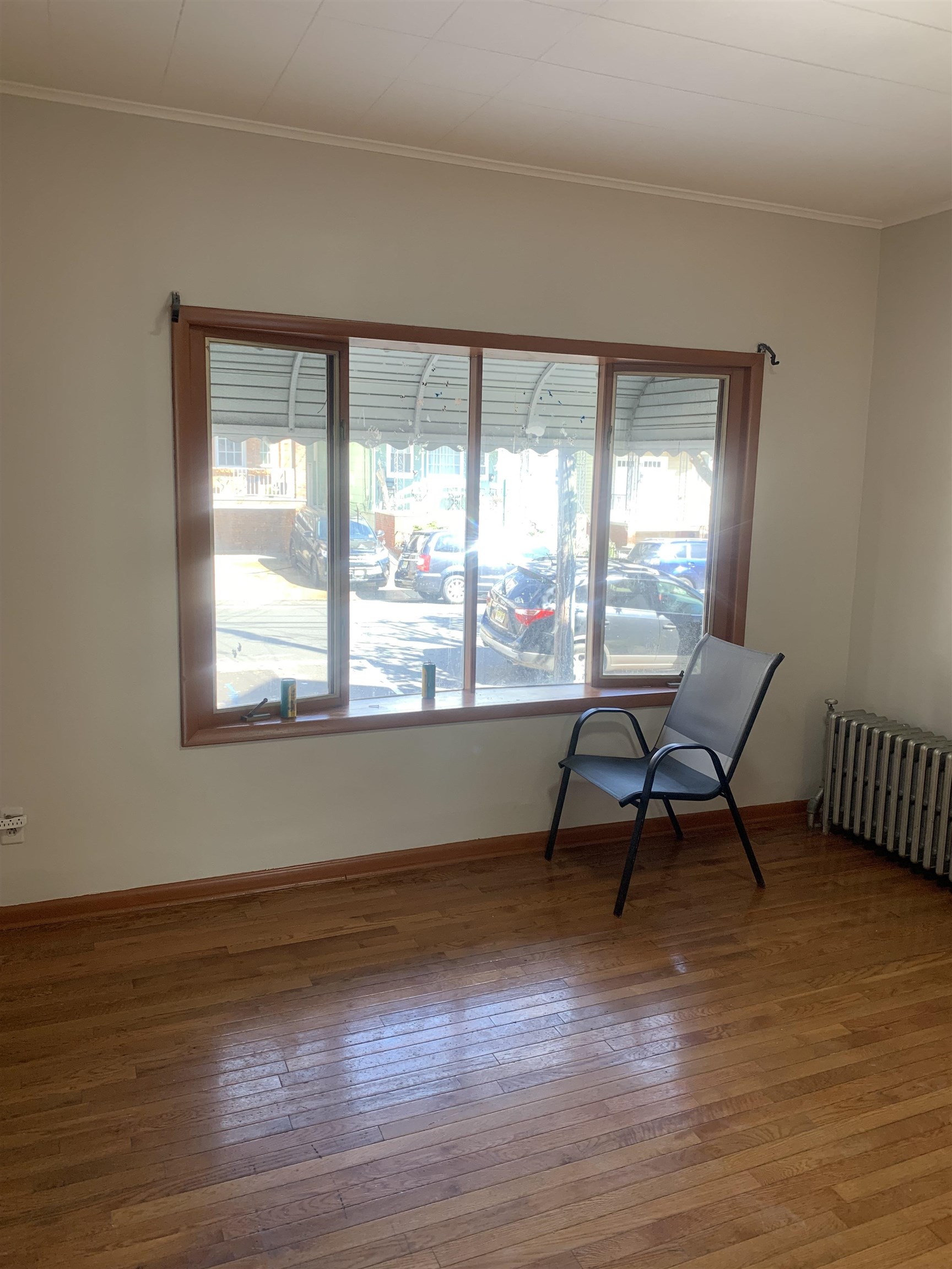 a workspace room with wooden floor and a window