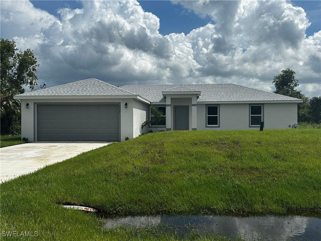 a front view of a house with a garden