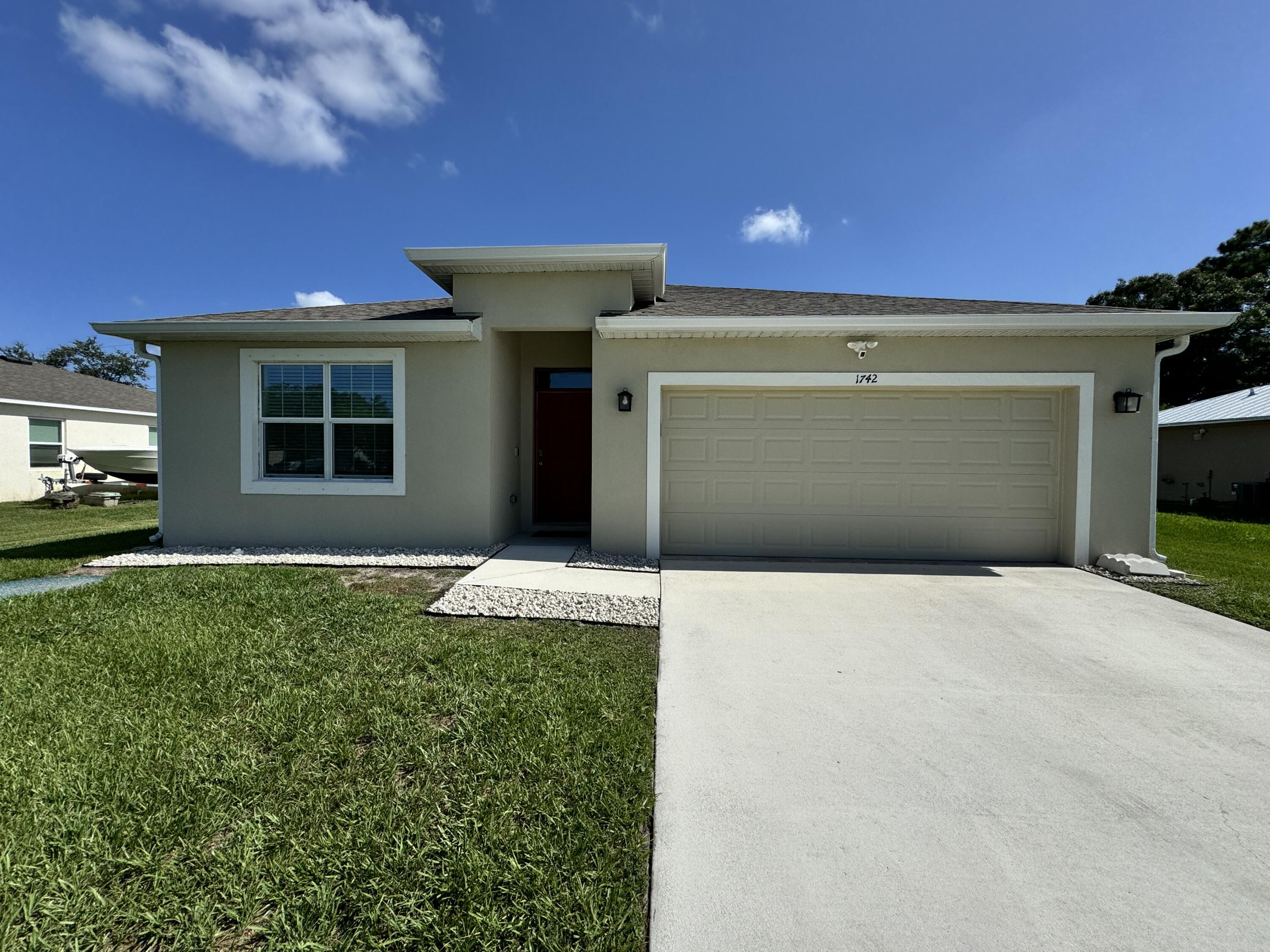 a front view of a house with a yard