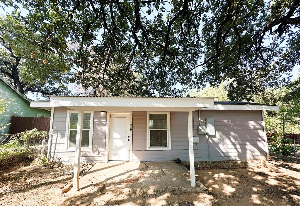 a view of a house with a tree