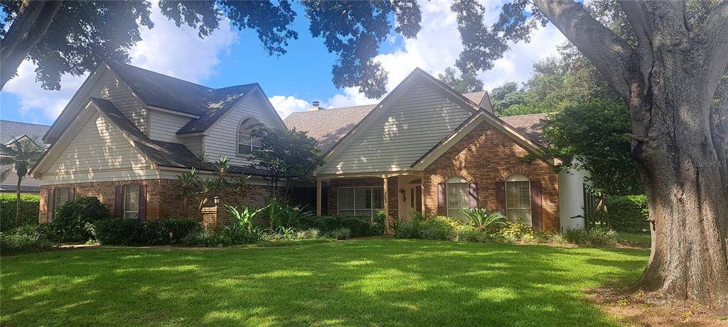 a front view of house with yard and green space