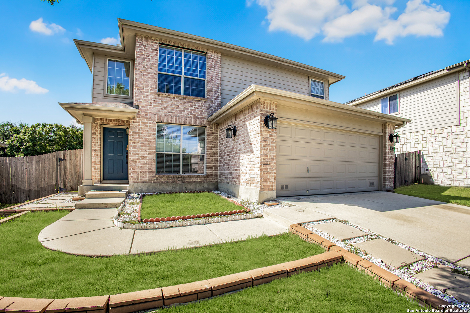 a front view of a house with a yard and garage