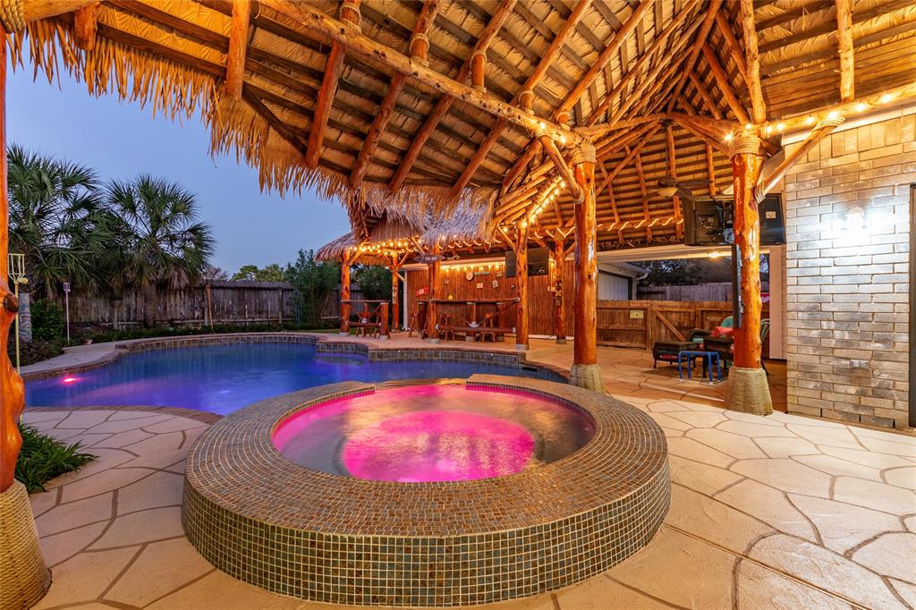 Secluded Residence in Highly Sought After South Shore Harbour. Impeccably Revitalized Resort Style Home! This backyard features a palapa with artificial fire-proof 20year thatched roof in 2019 with Cat II Windstorm rating, ambient lighting, and a stunning pool with an adjoining hot tub. Perfect for entertaining or relaxing in a private oasis.