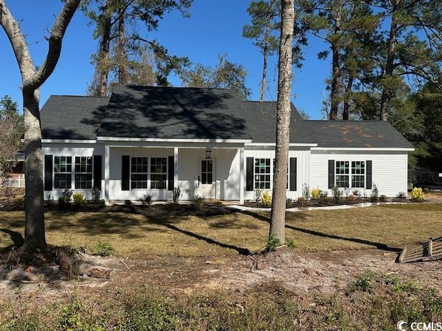 Rear view of property featuring a lawn