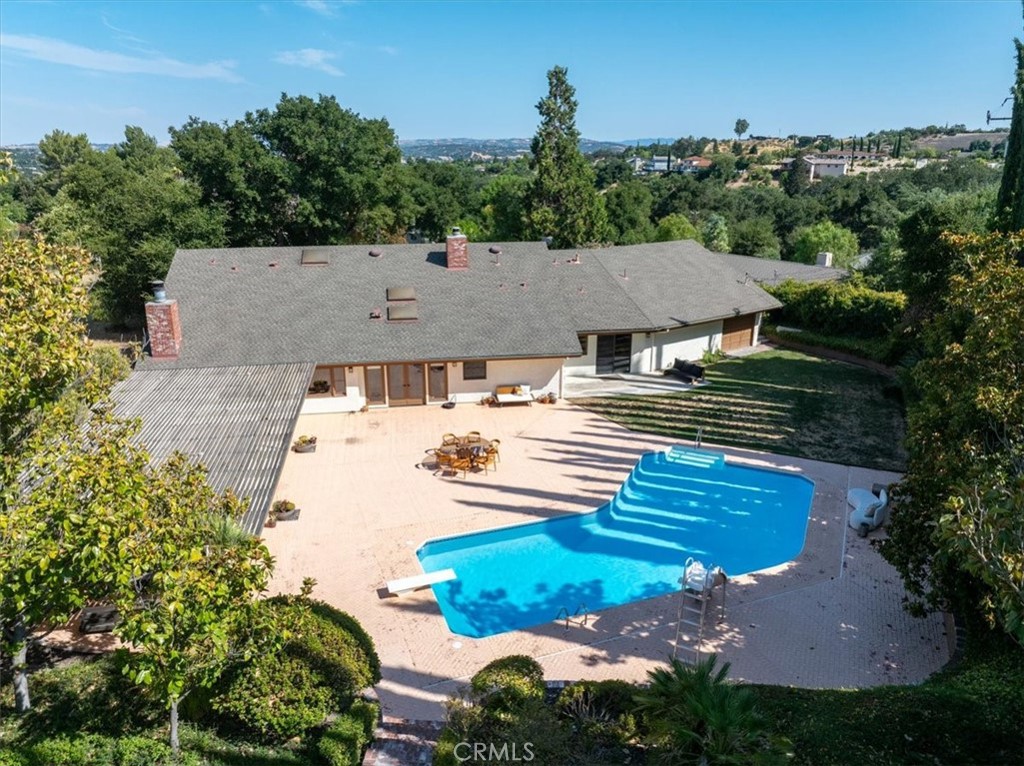 an aerial view of a house with yard swimming pool and outdoor seating