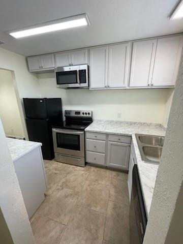 a kitchen with stainless steel appliances a stove sink and microwave