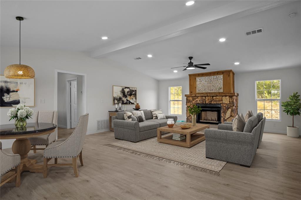 a living room with furniture a fireplace and a chandelier