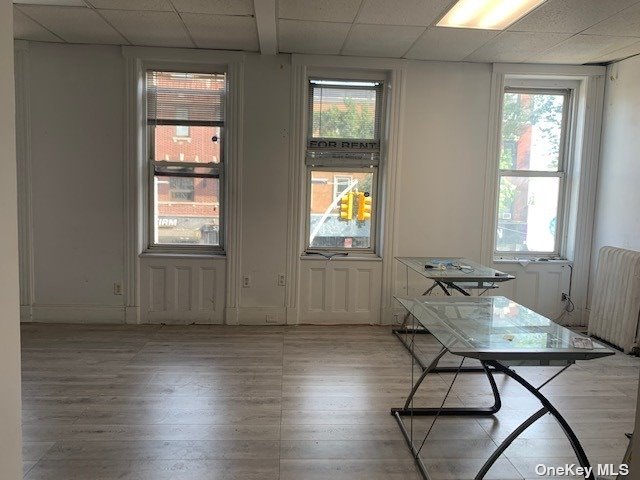 a workspace with wooden floor and windows