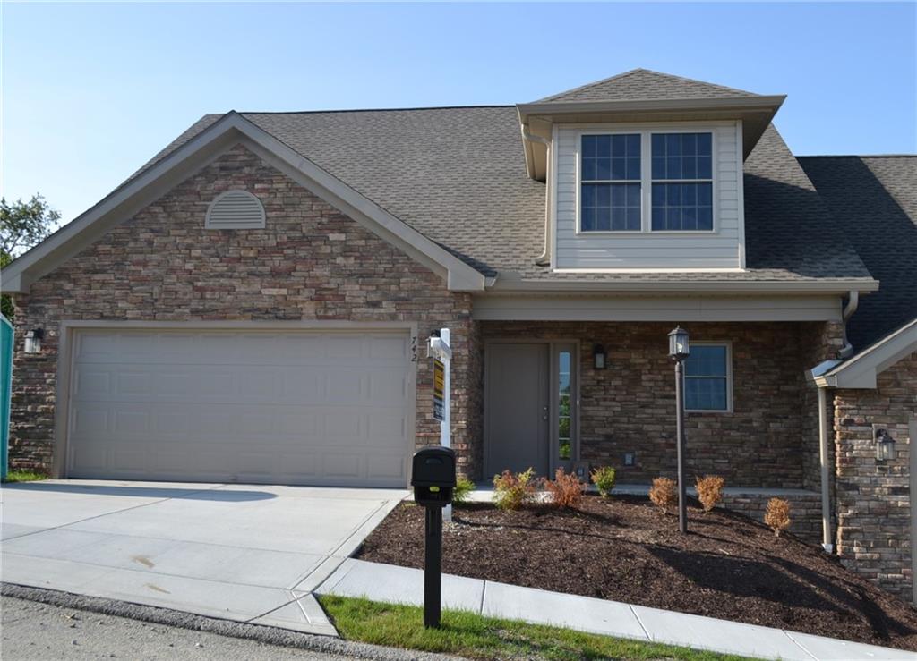 a front view of a house with garage