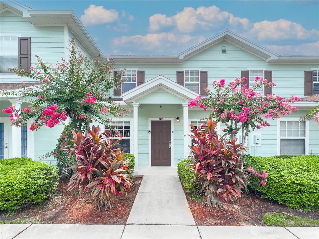 a front view of house with flowers