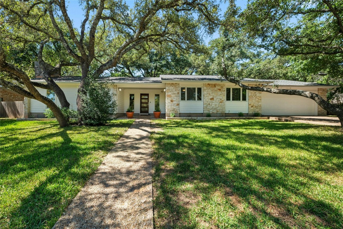 a front view of house with yard and green space