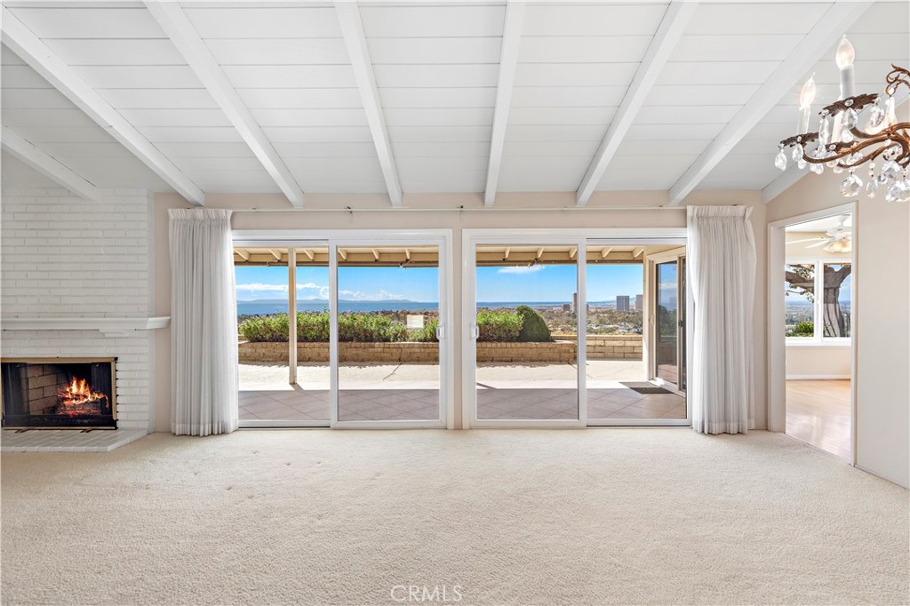 a view of an empty room with a fireplace and a window