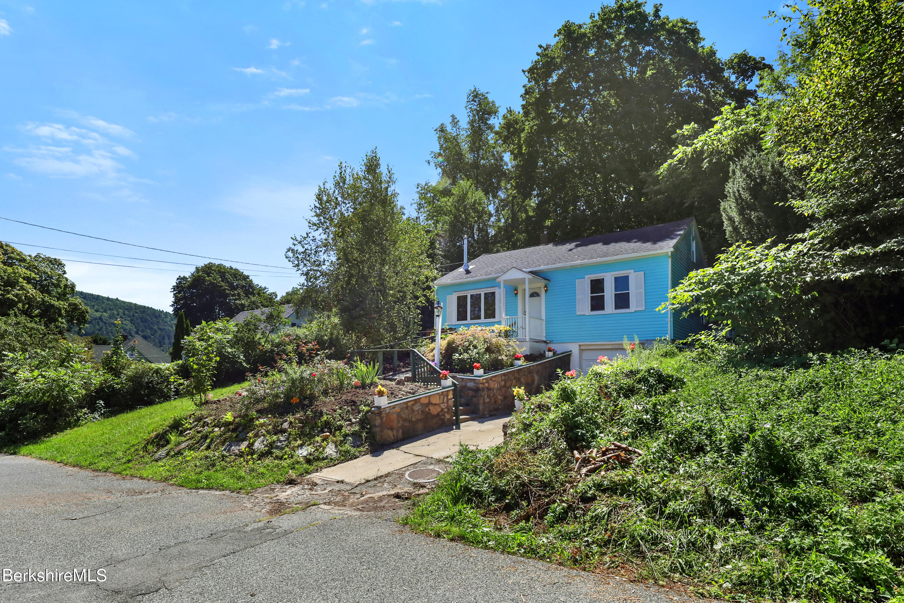 a front view of a house with garden