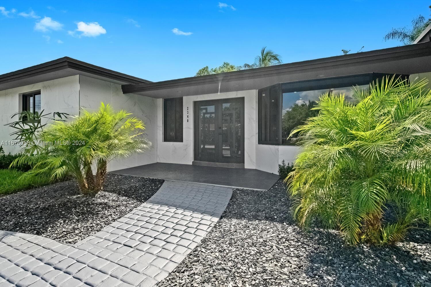 a front view of a house with garden