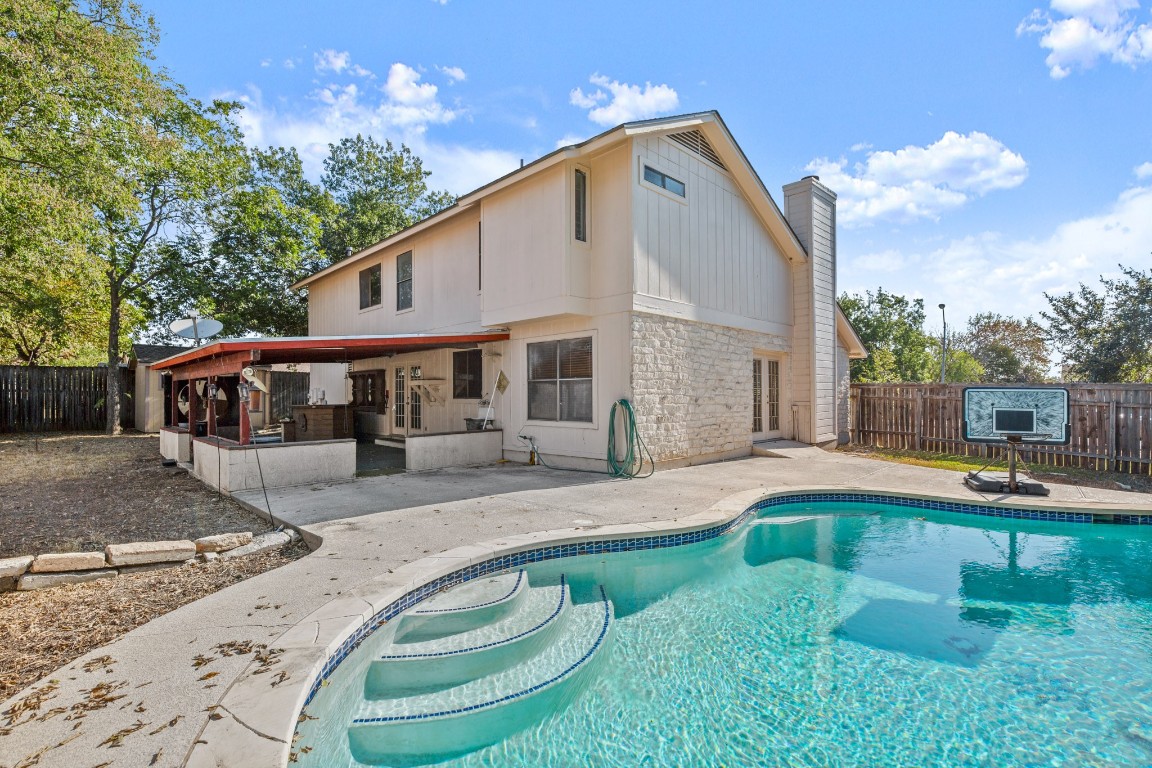 a view of a house with backyard sitting area and garden