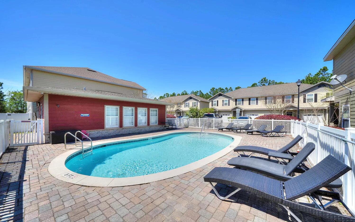 a view of a swimming pool with chairs