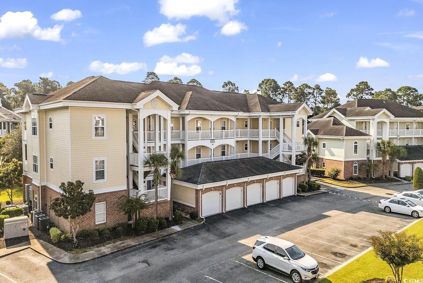 View of building exterior featuring a garage and c