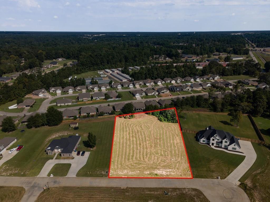 an aerial view of a house with a garden and lake view