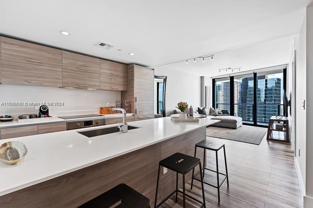 a large white kitchen with a large window