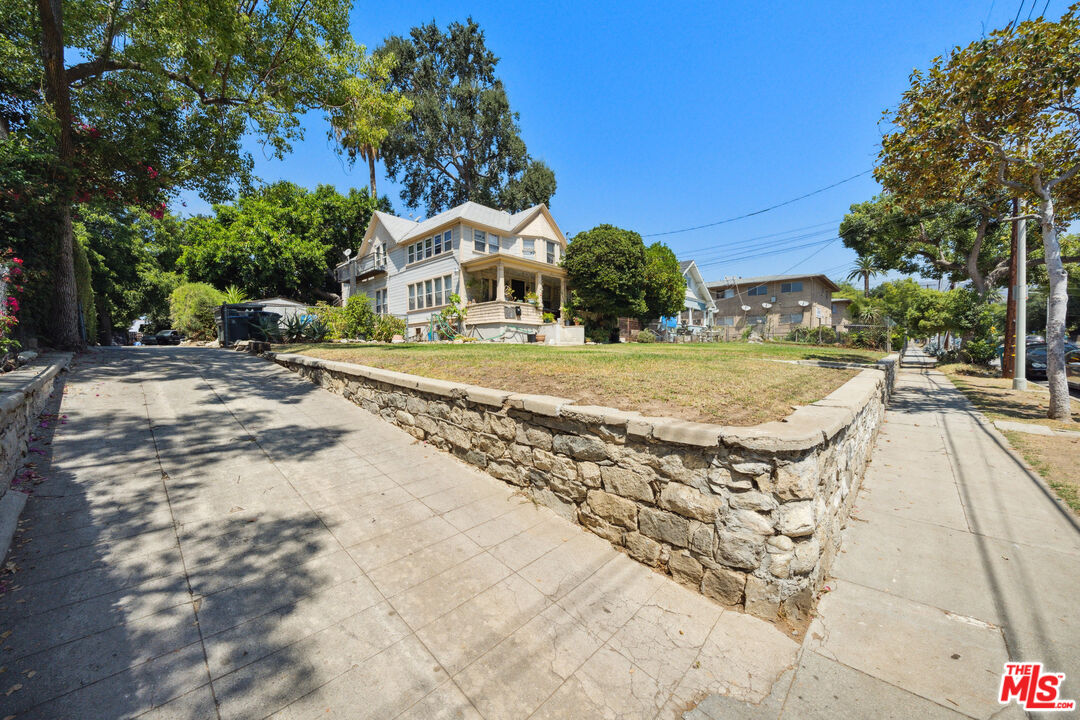 a view of a swimming pool with a house in the background