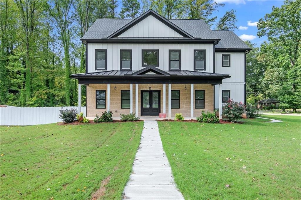 a front view of a house with a yard and trees