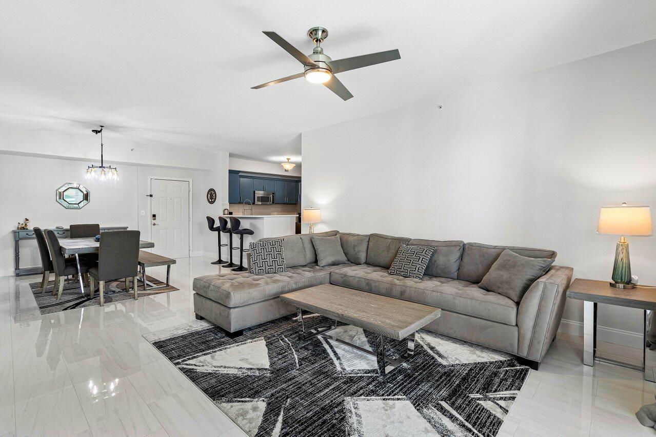 a living room with furniture and kitchen view