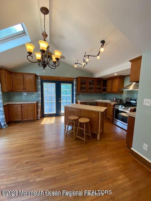 a view of a dining room with furniture a chandelier and wooden floor