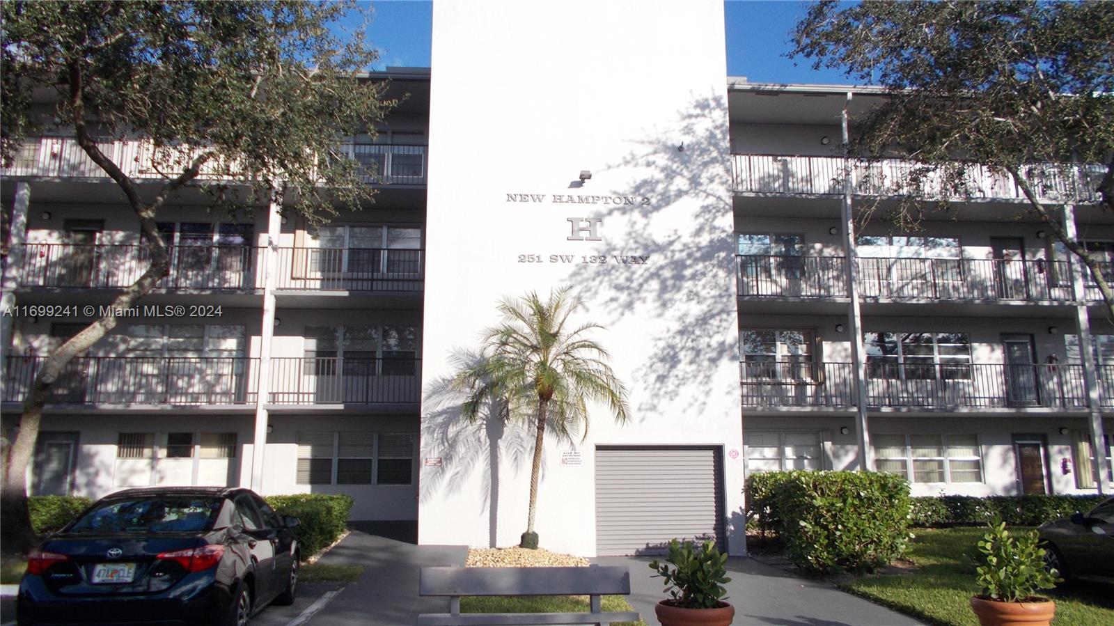 a front view of a building with tree s