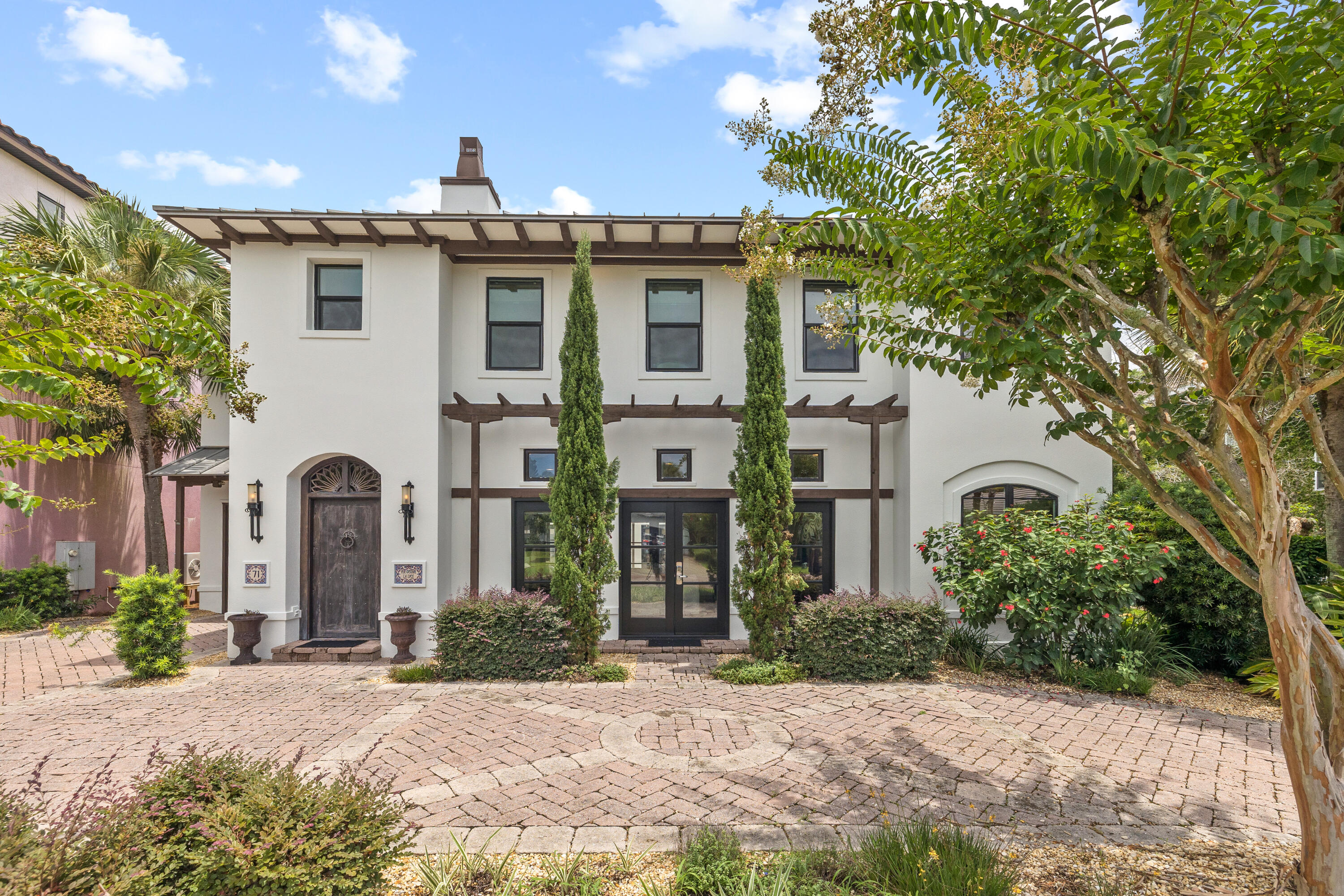 a front view of a house with a garden