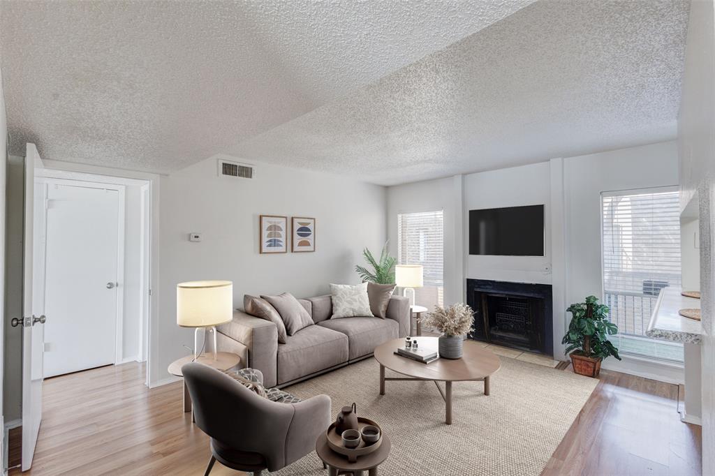 a living room with furniture a fireplace and a flat screen tv