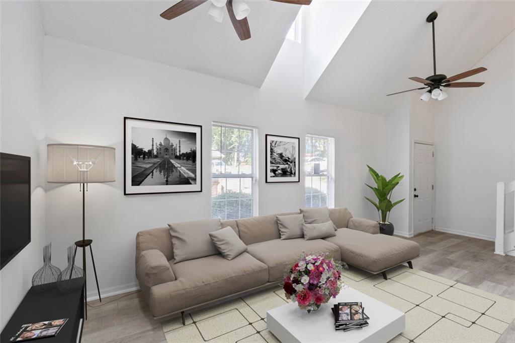 a living room with furniture and a potted plant