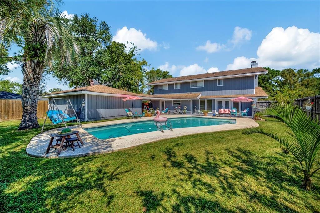 a front view of house with yard and outdoor seating