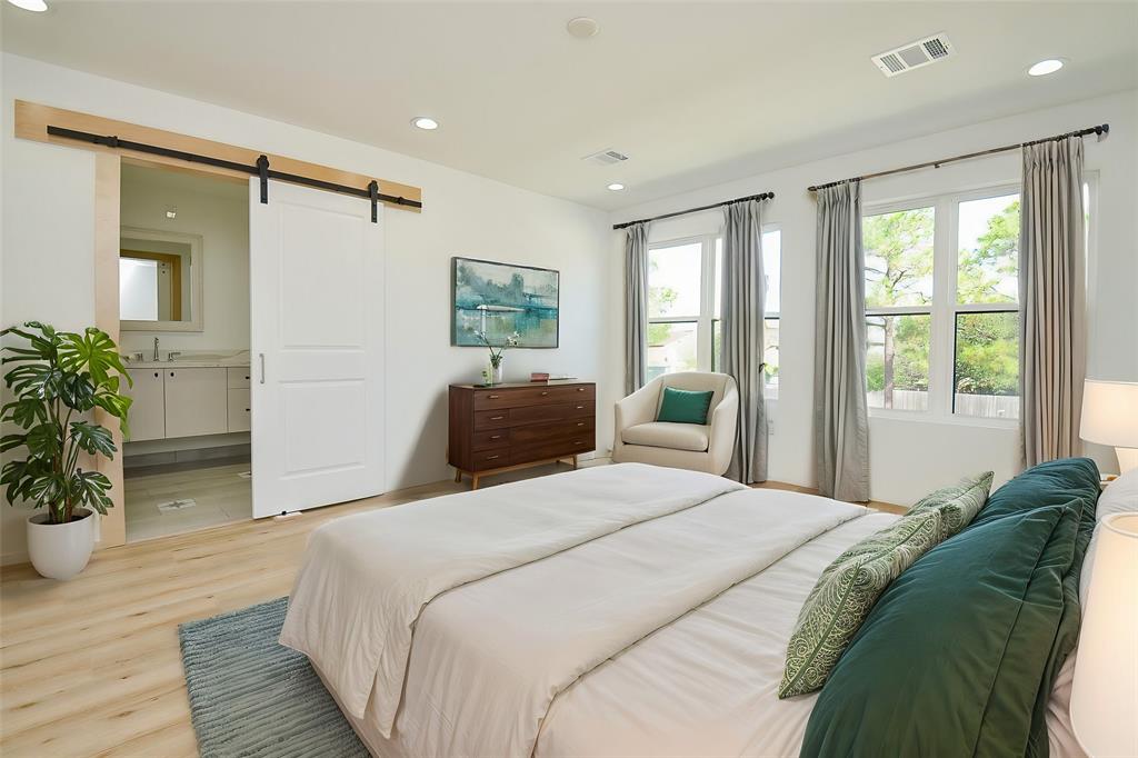 a bedroom with a bed and a potted plant