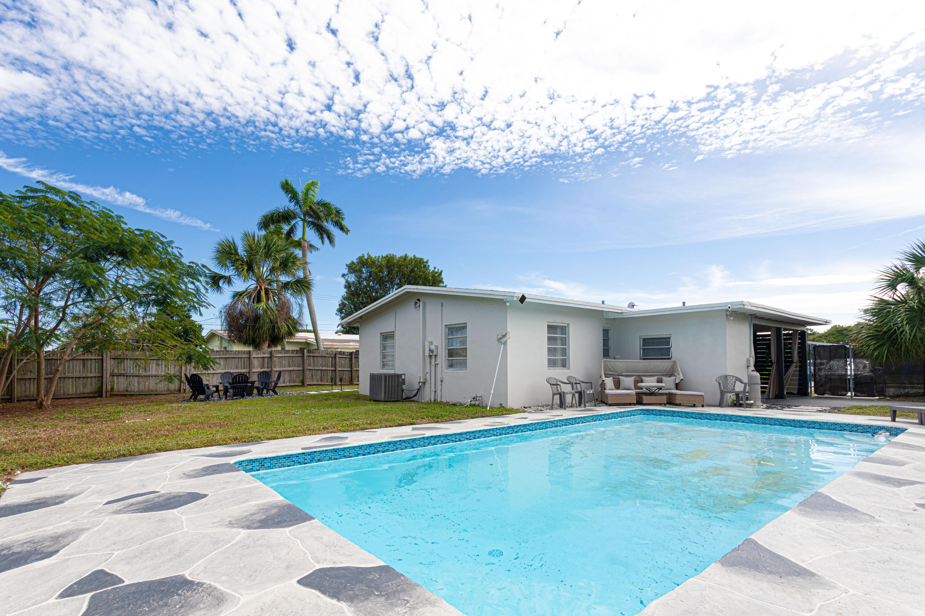 a view of a house with swimming pool and a yard