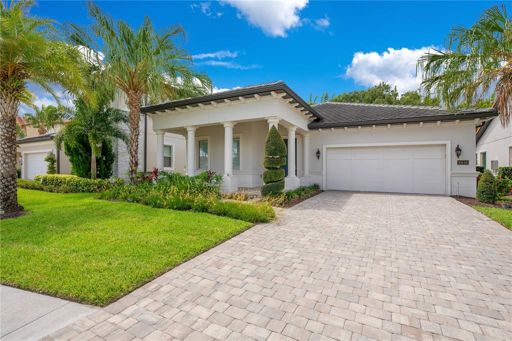 a front view of a house with a garden and yard