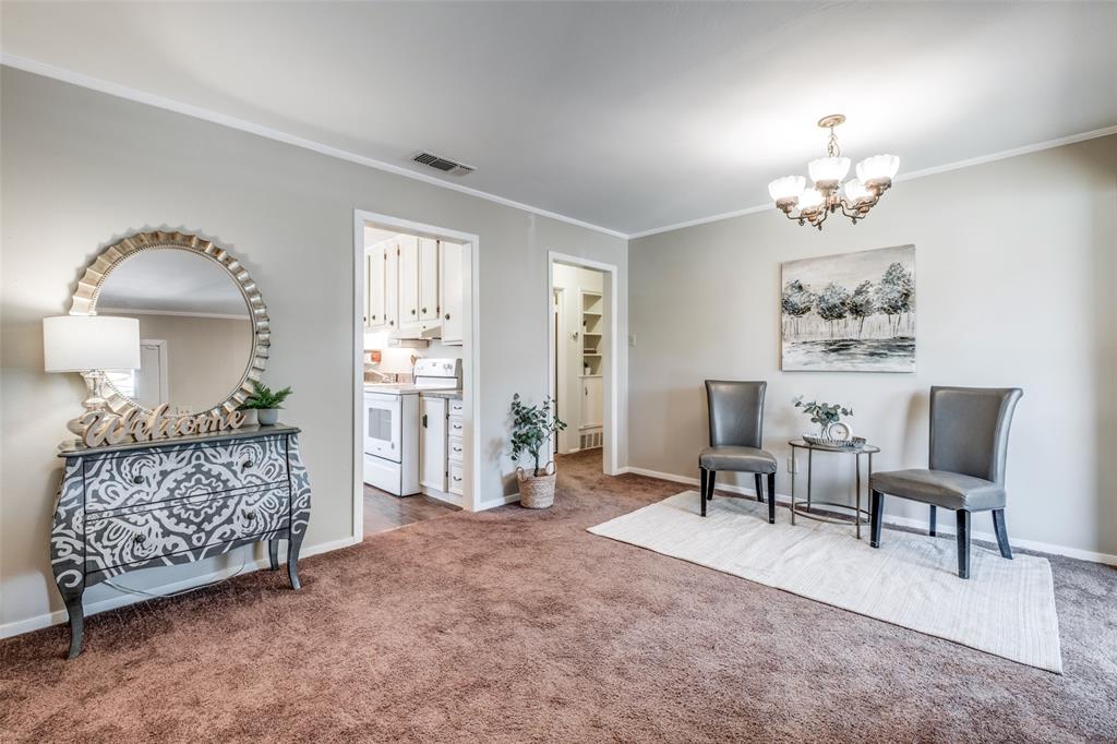 a living room with furniture a chandelier and a window