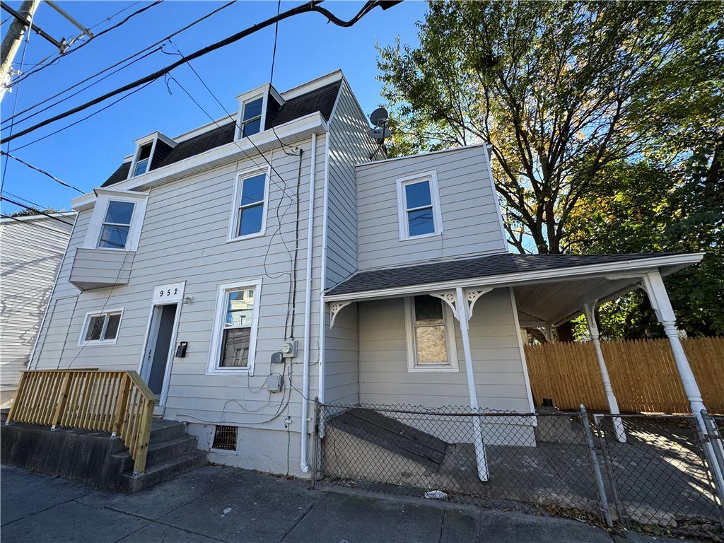 front view of a house with a bench