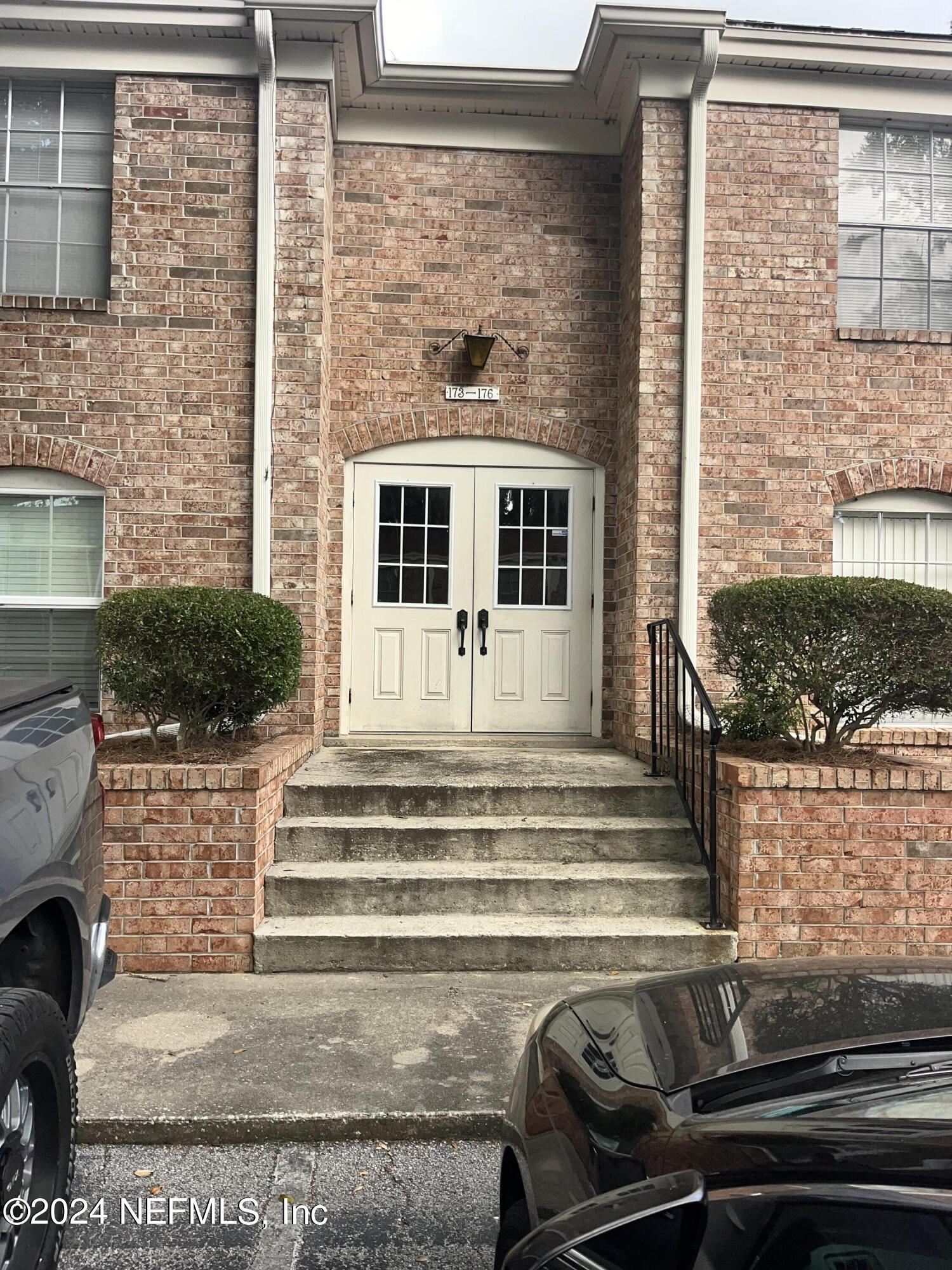 a view of a house with a door and a yard