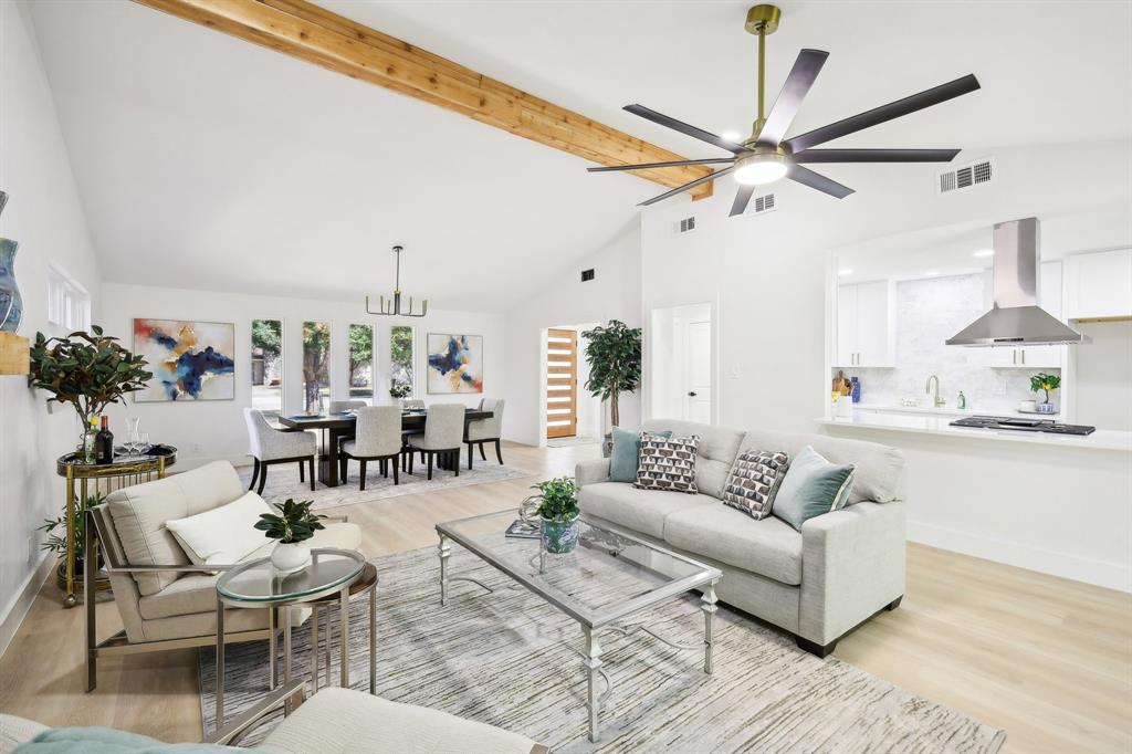 a living room with furniture and a chandelier