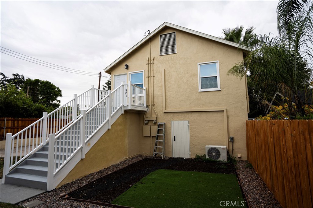 a view of a house with wooden fence