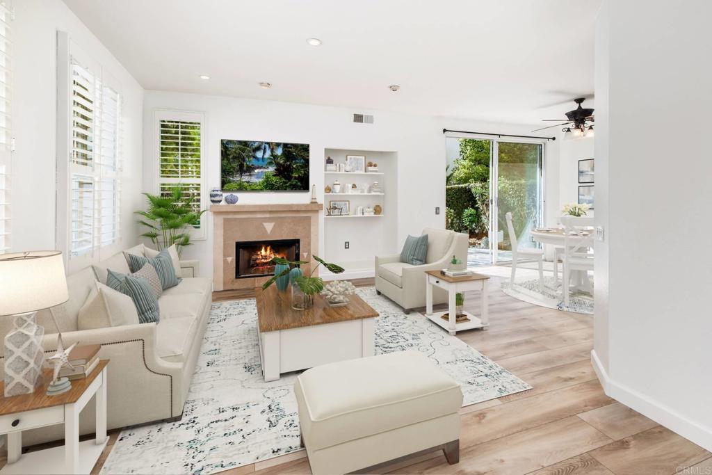 a living room with furniture a flat screen tv and a fireplace