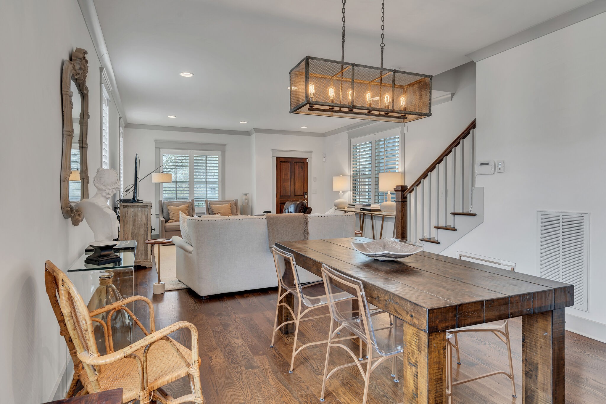 a view of a livingroom with furniture wooden floor and a chandelier