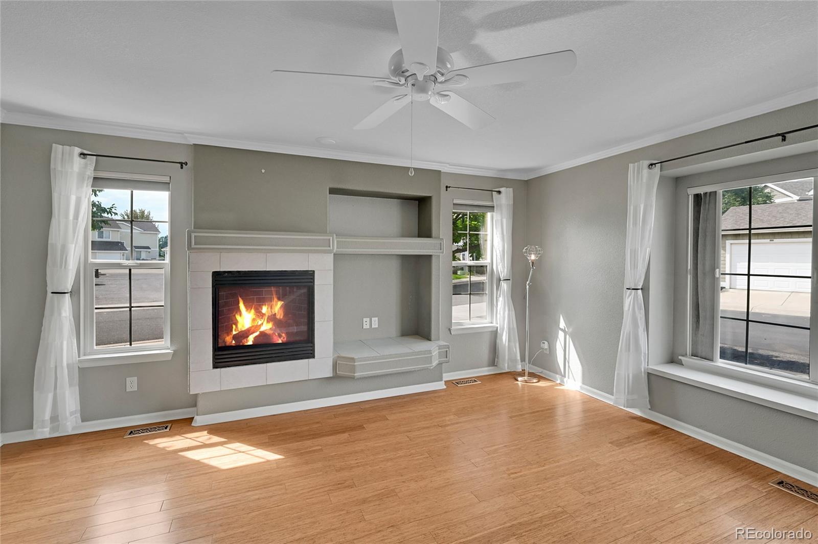 a view of an empty room with window and fire place